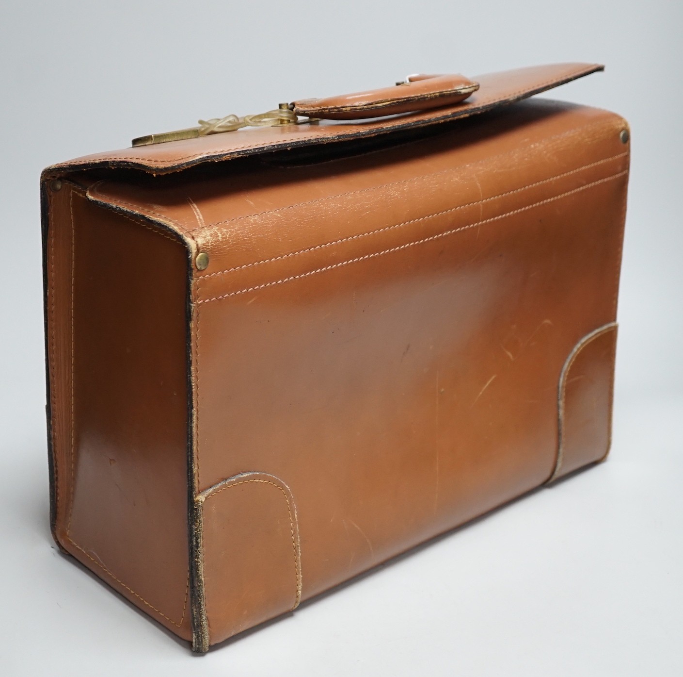 A leather case, proprorted to have once belonged to Roger Daltrey of The Who, with Tidal Wave Productions label